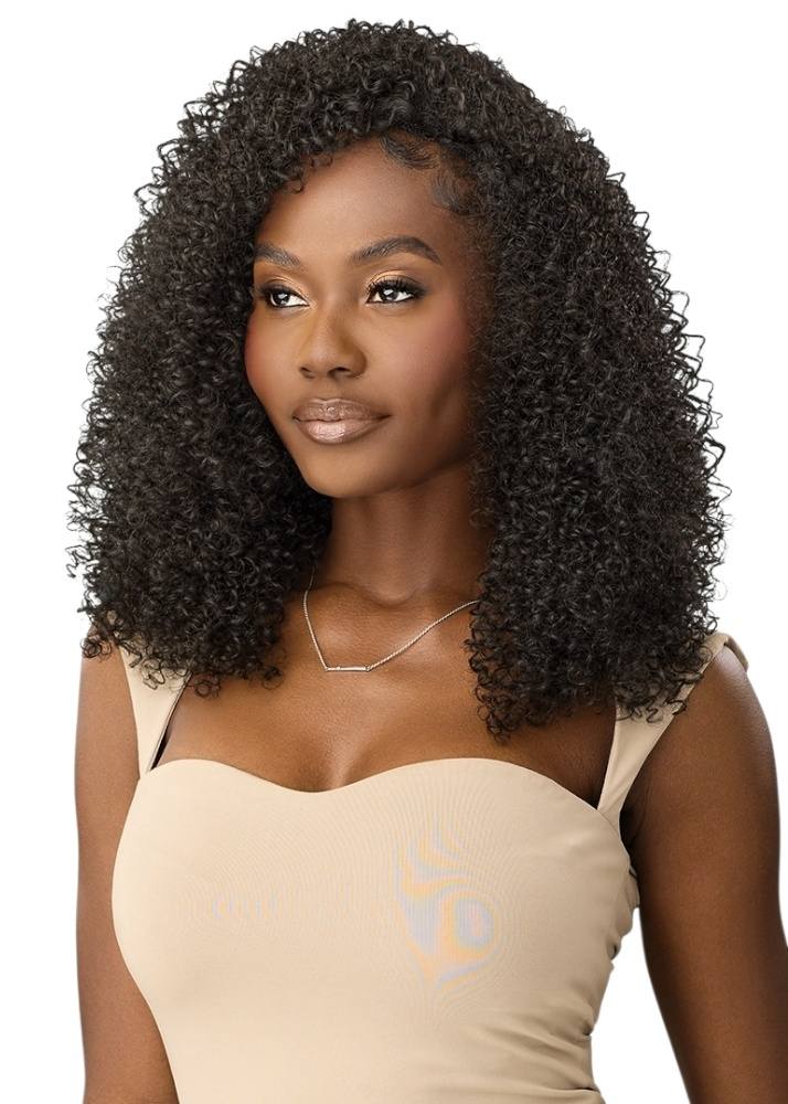 Woman with coily hair wearing a beige top on a white background Outre Aurayna 