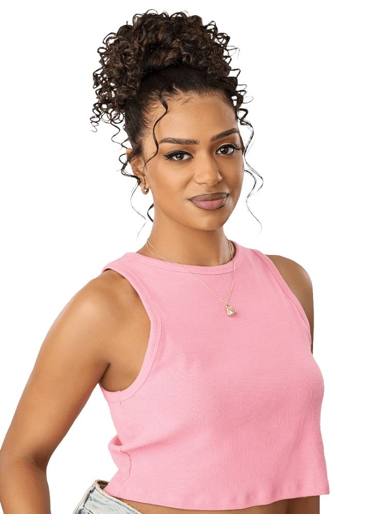 curly brown hair styled in a high bun with long curly tendrils wears a light pink sleeveless crop top. 