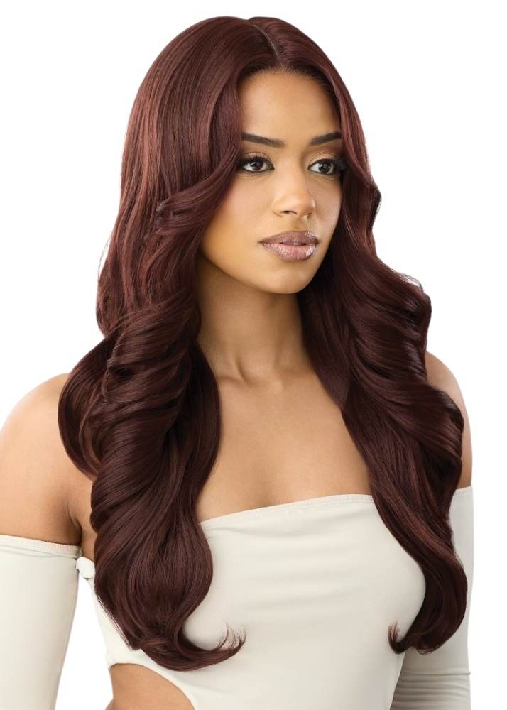 Outre CB 104 Woman with long, wavy brown wig wearing a white top on a white background